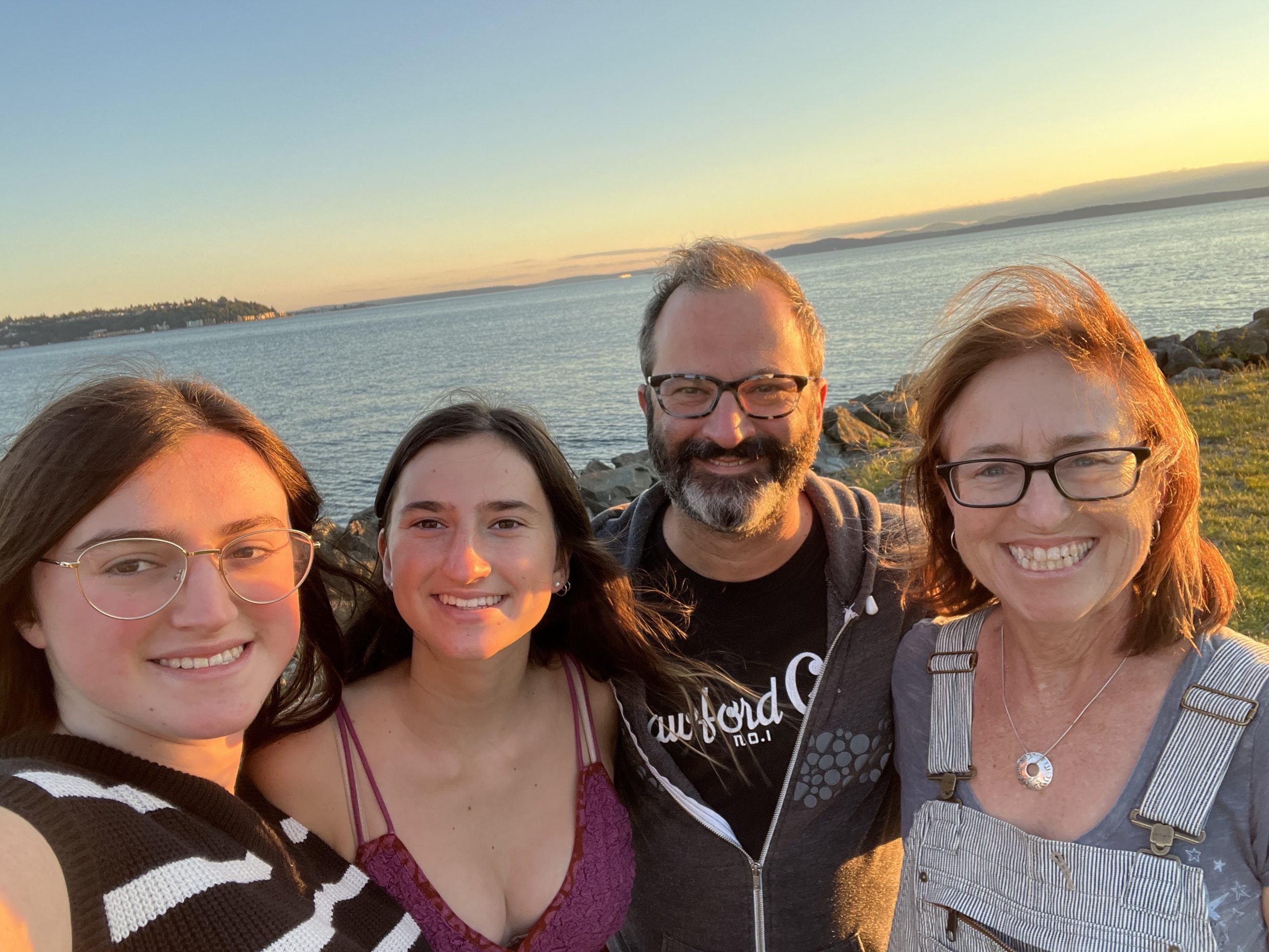 Family standing near a beach.