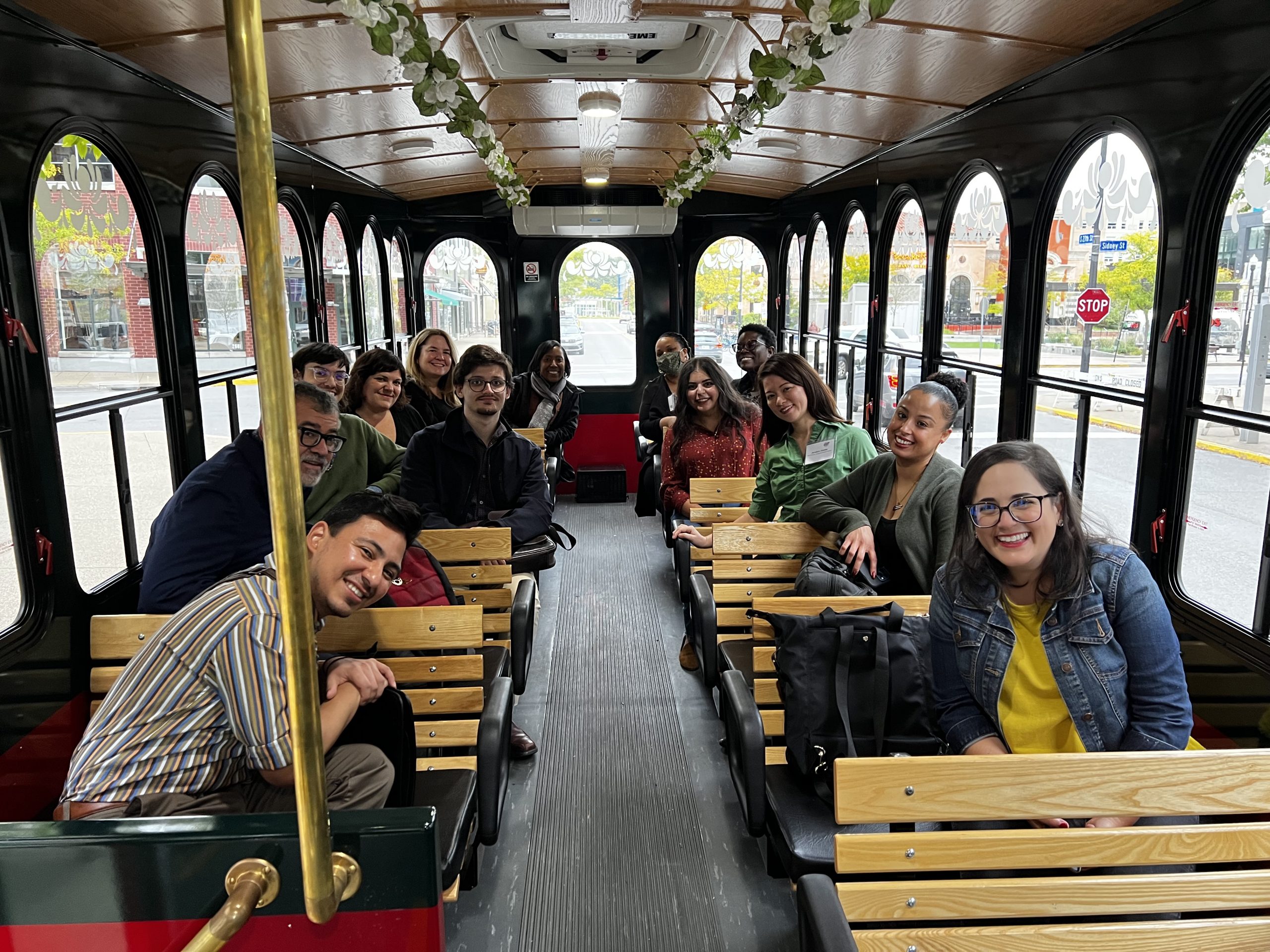 Fellows sitting together on a trolley.