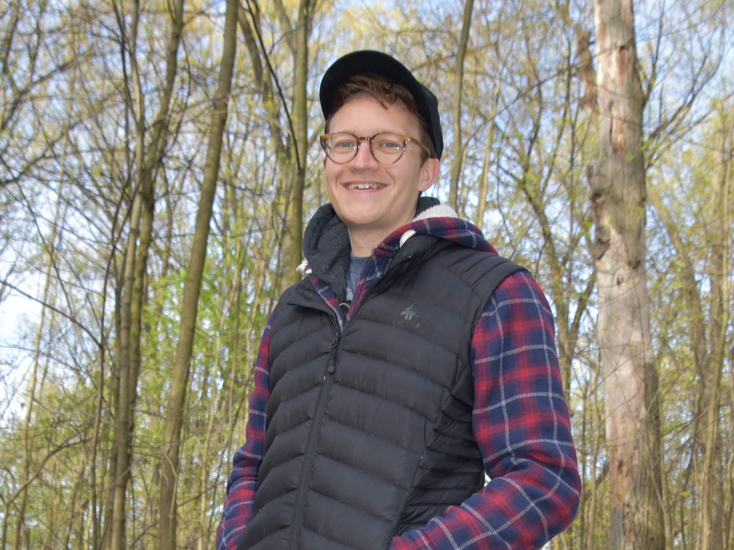 Daniel standing in front of trees.