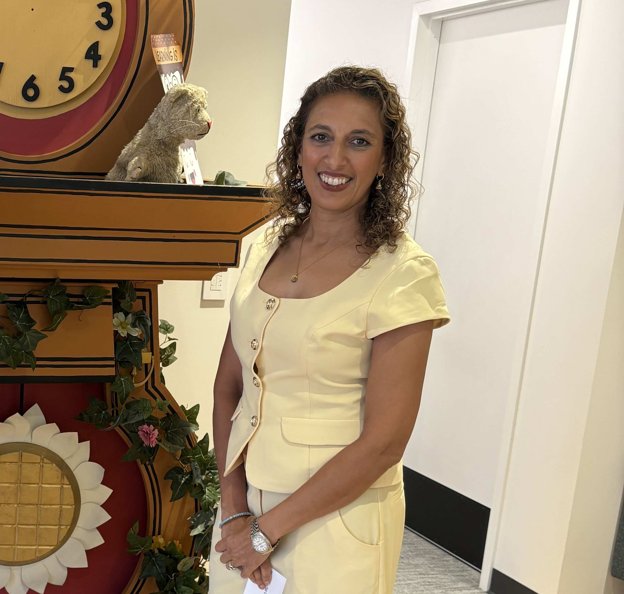 Natascha standing in front of Daniel Striped Tiger's clock.